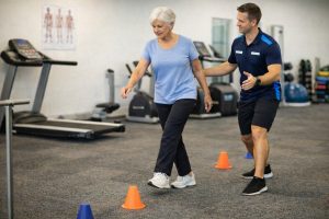Older adult performing supervised dynamic balance and stepping exercises as part of a falls prevention program